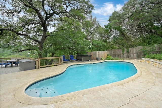 2009 S Oak Canyon Rd, Austin, TX 78746 - view of swimming pool with a wooden deck, view of scattered trees, and a hot tub