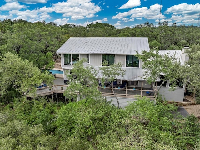 2009 S Oak Canyon Rd, Austin, TX 78746 - back of house featuring metal roof and a forest view
