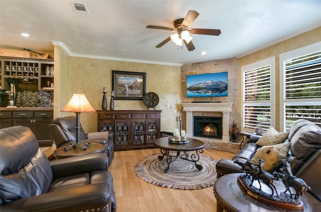 107 Lachite Unit 6, Horseshoe Bay, TX 78657 - living room featuring wood finished floors, ceiling fan, a fireplace, and crown molding