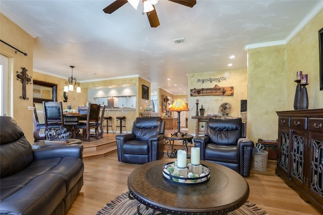 107 Lachite Unit 6, Horseshoe Bay, TX 78657 - living room featuring wood finished floors, ceiling fan, ornamental molding, and a chandelier