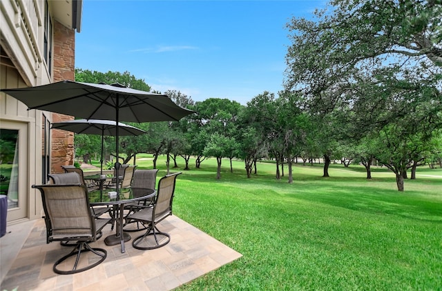 107 Lachite Unit 6, Horseshoe Bay, TX 78657 - view of grassy yard with outdoor dining space and a patio area