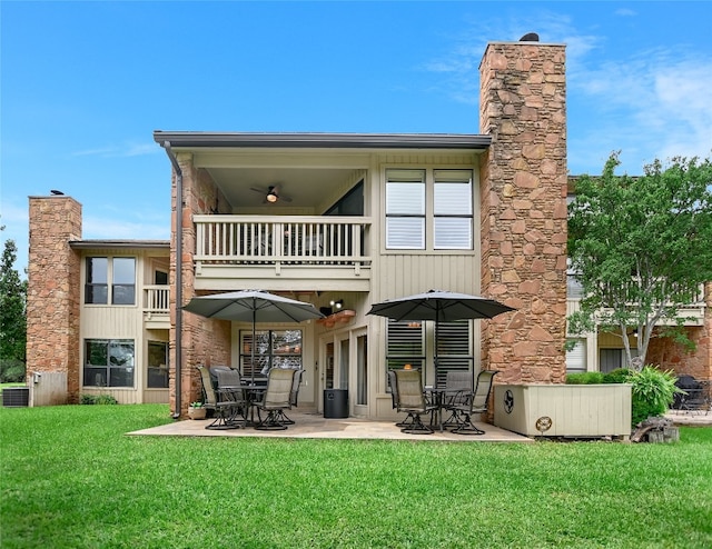 107 Lachite Unit 6, Horseshoe Bay, TX 78657 - back of house with a balcony, a yard, a patio area, central AC unit, and a chimney