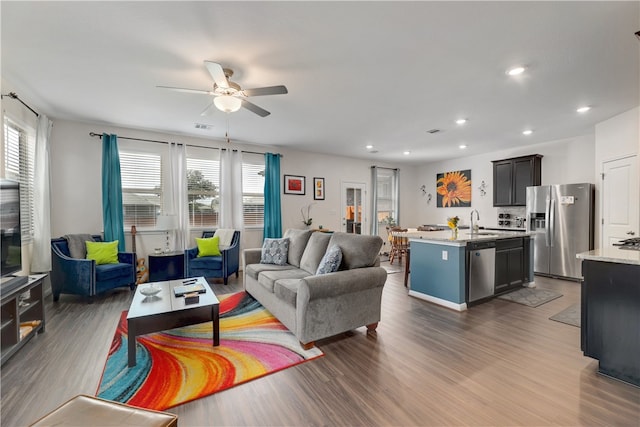 109 Red Cedar Ct, Georgetown, TX 78628 - living area with healthy amount of natural light, a ceiling fan, wood finished floors, and recessed lighting