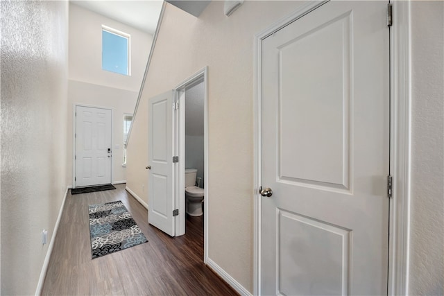 109 Red Cedar Ct, Georgetown, TX 78628 - hall featuring dark wood-type flooring, baseboards, and a towering ceiling
