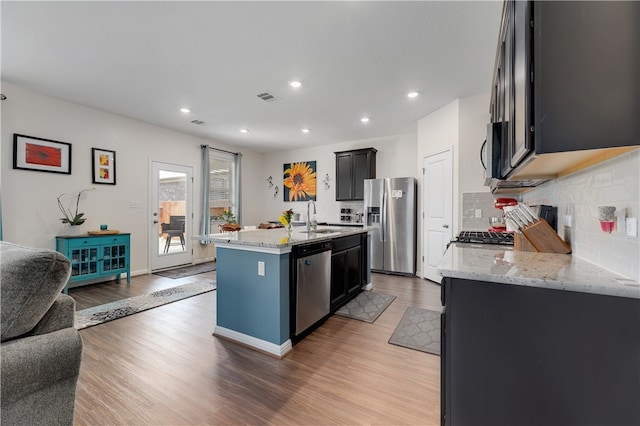 109 Red Cedar Ct, Georgetown, TX 78628 - kitchen with appliances with stainless steel finishes, an island with sink, backsplash, a sink, and recessed lighting