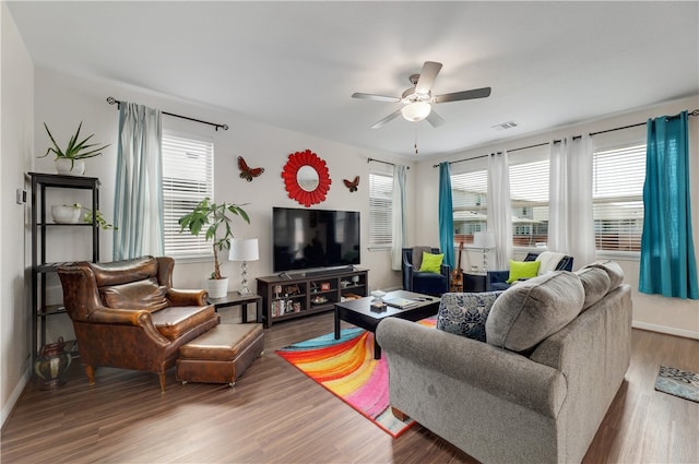 109 Red Cedar Ct, Georgetown, TX 78628 - living area with healthy amount of natural light, wood finished floors, a ceiling fan, and baseboards