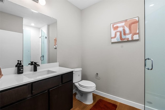 2505 Thornton Rd Unit 1312, Austin, TX 78704 - full bathroom with wood finished floors, a shower stall, baseboards, vanity, and toilet