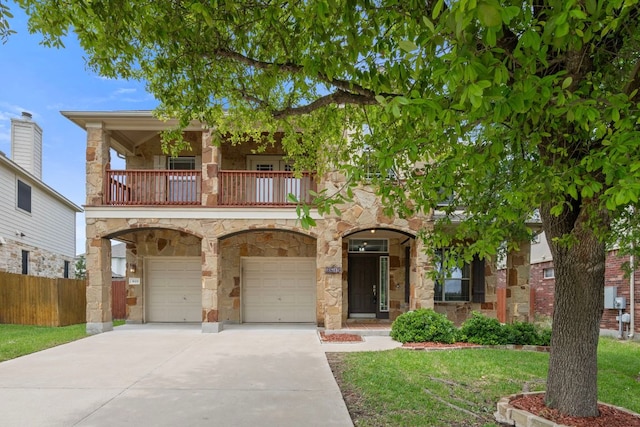 3619 Fossilwood Way, Round Rock, TX 78681 - view of front of home with a balcony, stone siding, an attached garage, and driveway