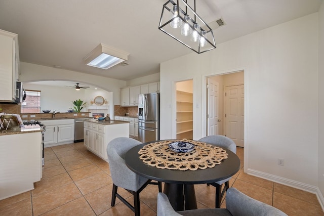 3619 Fossilwood Way, Round Rock, TX 78681 - dining space with arched walkways, light tile patterned flooring, and ceiling fan