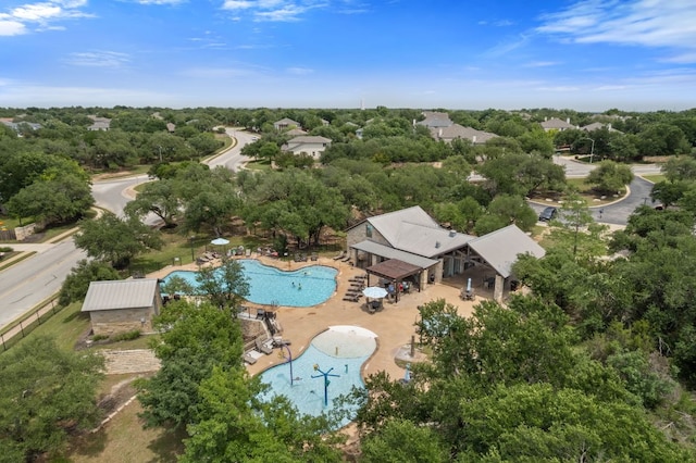 3619 Fossilwood Way, Round Rock, TX 78681 - aerial view of a pool and a tree filled landscape