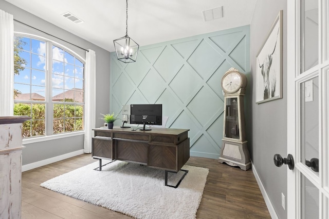 2516 Rusty Spur, Leander, TX 78641 - office space featuring baseboards, plenty of natural light, a chandelier, wood finished floors, and a decorative wall
