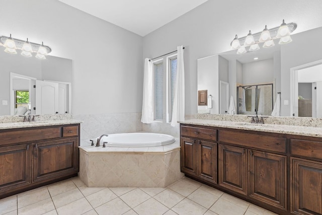 2516 Rusty Spur, Leander, TX 78641 - bathroom with two vanities, a garden tub, tile patterned floors, and a stall shower