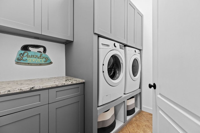2516 Rusty Spur, Leander, TX 78641 - laundry area featuring cabinet space, washer and clothes dryer, and light tile patterned flooring