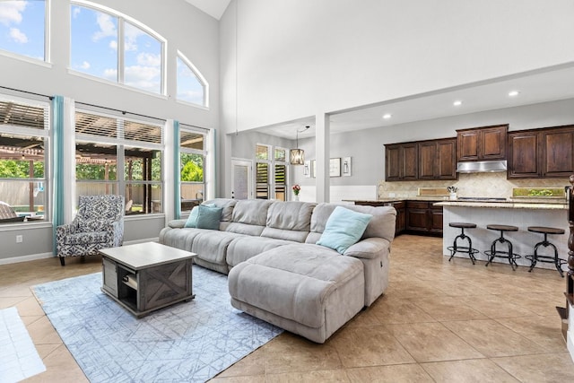 2516 Rusty Spur, Leander, TX 78641 - living area featuring light tile patterned floors, recessed lighting, a high ceiling, and baseboards
