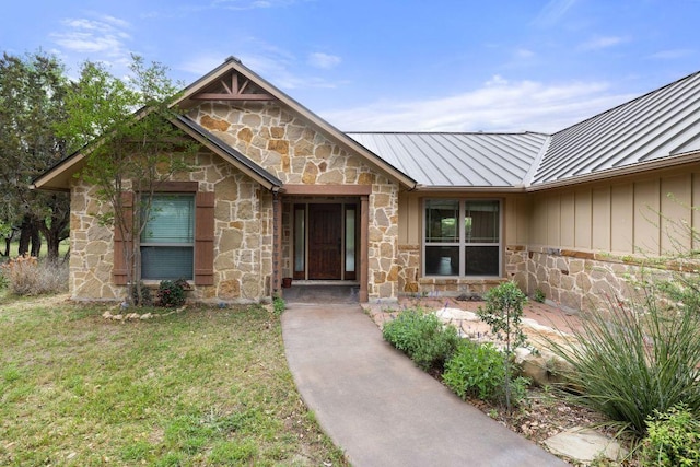 215 Maverick Cir, Horseshoe Bay, TX 78657 - doorway to property with a standing seam roof, stone siding, metal roof, and a yard