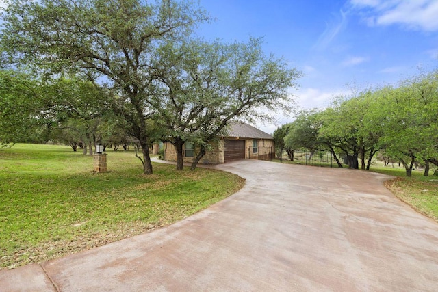 215 Maverick Cir, Horseshoe Bay, TX 78657 - view of front of property with concrete driveway, a front lawn, and a garage