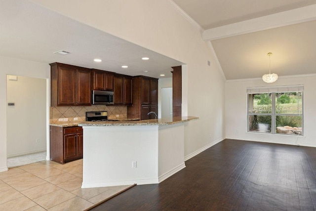 215 Maverick Cir, Horseshoe Bay, TX 78657 - kitchen with appliances with stainless steel finishes, light stone countertops, tasteful backsplash, baseboards, and ornamental molding