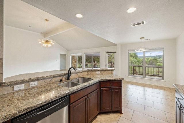 215 Maverick Cir, Horseshoe Bay, TX 78657 - kitchen with a sink, dishwasher, light stone counters, light tile patterned floors, and decorative light fixtures
