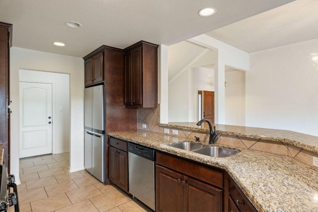 215 Maverick Cir, Horseshoe Bay, TX 78657 - kitchen featuring stainless steel appliances, a sink, light stone countertops, backsplash, and light tile patterned floors