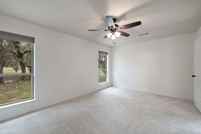 215 Maverick Cir, Horseshoe Bay, TX 78657 - empty room featuring healthy amount of natural light, a ceiling fan, carpet floors, and baseboards