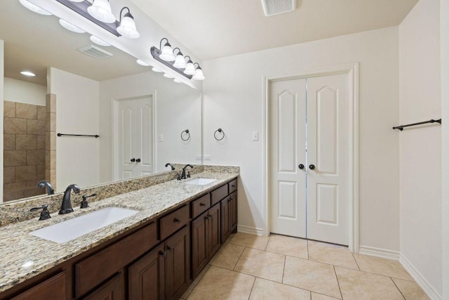 215 Maverick Cir, Horseshoe Bay, TX 78657 - bathroom with baseboards, double vanity, and tile patterned flooring