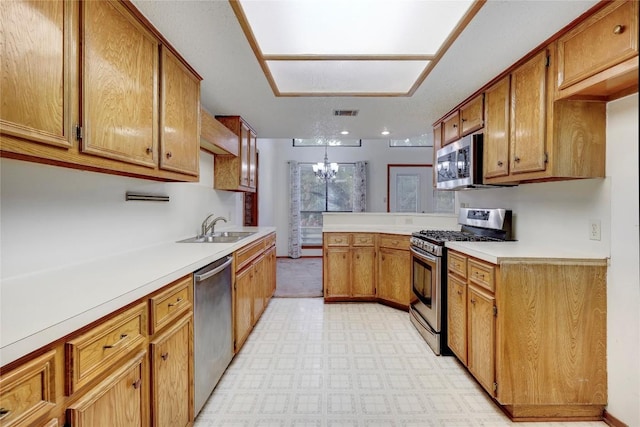 612 Tumlinson Fort Dr, Leander, TX 78641 - kitchen featuring stainless steel appliances, a sink, brown cabinets, and light countertops