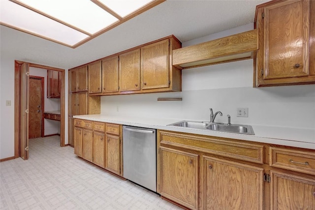 612 Tumlinson Fort Dr, Leander, TX 78641 - kitchen with stainless steel dishwasher, brown cabinetry, light countertops, and a sink