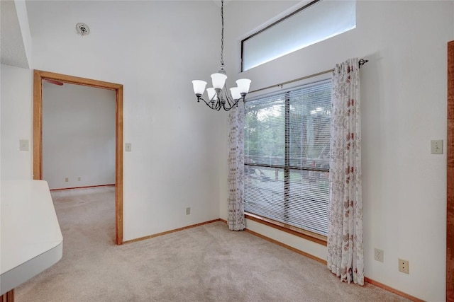 612 Tumlinson Fort Dr, Leander, TX 78641 - carpeted empty room with a chandelier, baseboards, and a towering ceiling