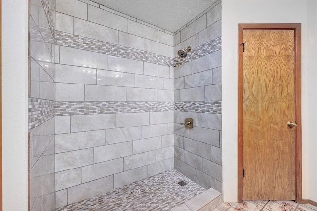 612 Tumlinson Fort Dr, Leander, TX 78641 - full bathroom featuring a tile shower and a textured ceiling