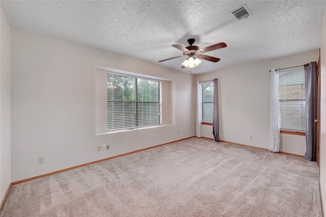 612 Tumlinson Fort Dr, Leander, TX 78641 - empty room featuring light carpet, ceiling fan, baseboards, and a textured ceiling