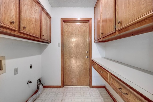 612 Tumlinson Fort Dr, Leander, TX 78641 - laundry room with hookup for an electric dryer, light floors, and cabinet space