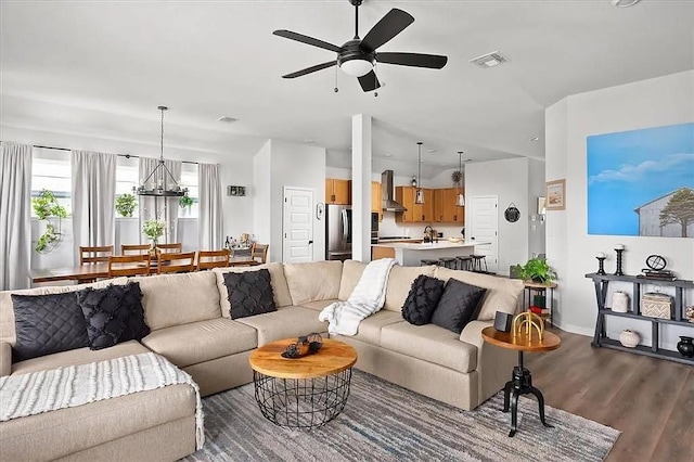 108 Charles Zanco Dr, Bastrop, TX 78602 - living area with a ceiling fan, dark wood-style floors, a chandelier, and baseboards