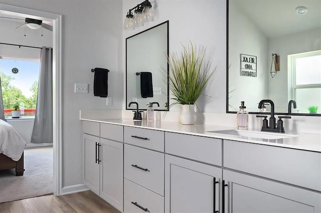108 Charles Zanco Dr, Bastrop, TX 78602 - ensuite bathroom featuring double vanity, plenty of natural light, and wood finished floors