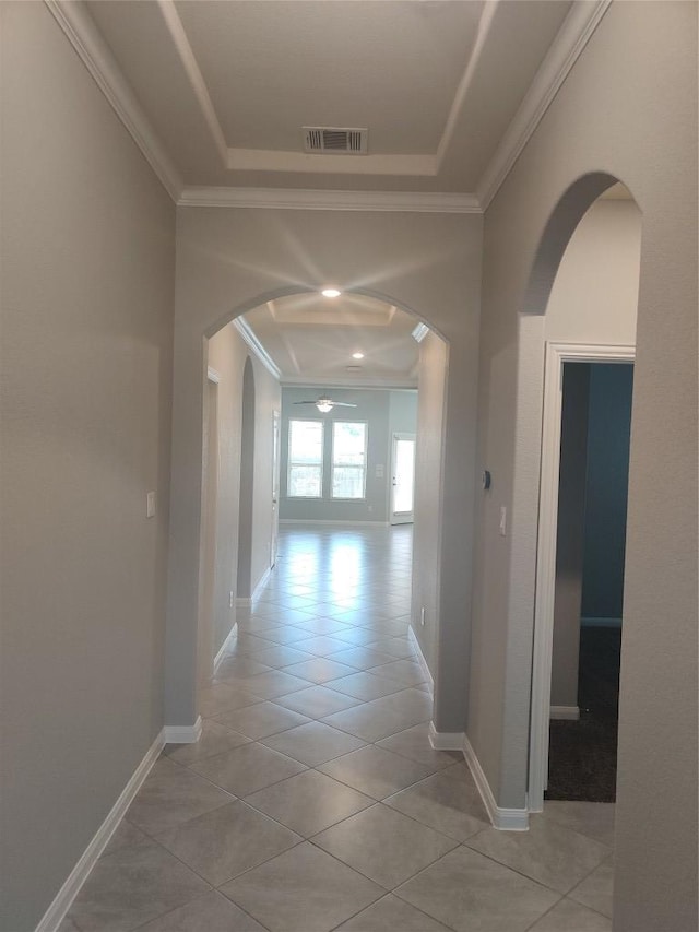 3332 Lauren Nicole Ln, Round Rock, TX 78665 - hall featuring ornamental molding, light tile patterned flooring, arched walkways, and a tray ceiling