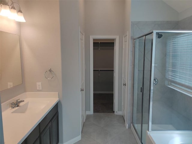 3332 Lauren Nicole Ln, Round Rock, TX 78665 - bathroom featuring a shower stall, tile patterned floors, vanity, a walk in closet, and baseboards