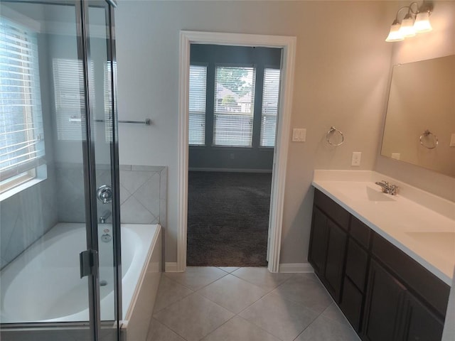 3332 Lauren Nicole Ln, Round Rock, TX 78665 - bathroom with a bath, baseboards, double vanity, tile patterned flooring, and an enclosed shower