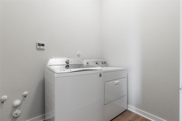8112 Silhouette St, Austin, TX 78744 - laundry area with washing machine and clothes dryer, baseboards, and dark wood finished floors