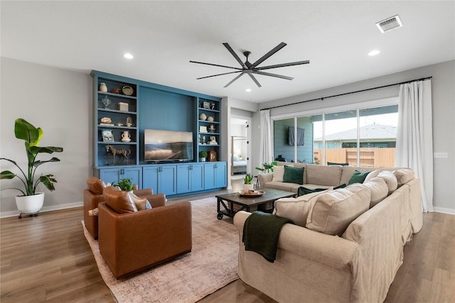 8112 Silhouette St, Austin, TX 78744 - living room featuring wood finished floors, a ceiling fan, recessed lighting, and baseboards