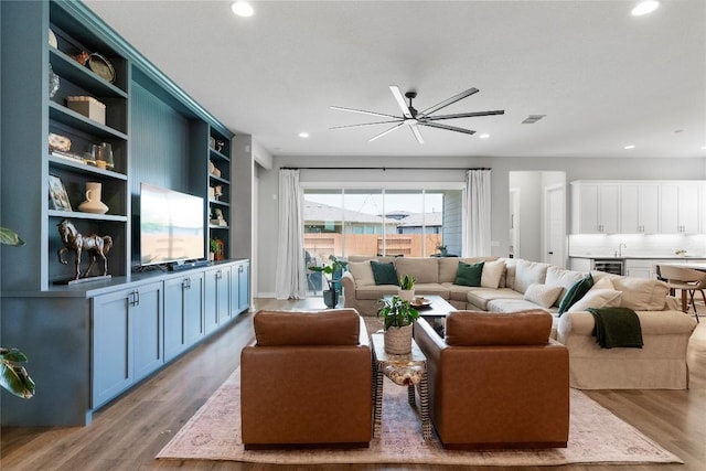 8112 Silhouette St, Austin, TX 78744 - living room with wood finished floors, recessed lighting, beverage cooler, and a ceiling fan