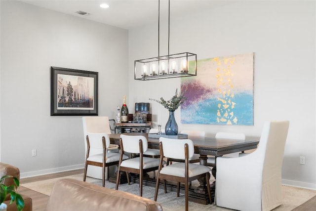 8112 Silhouette St, Austin, TX 78744 - dining area featuring wood finished floors, baseboards, a chandelier, and recessed lighting