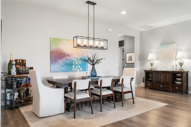 8112 Silhouette St, Austin, TX 78744 - dining space with wood finished floors, a chandelier, and recessed lighting