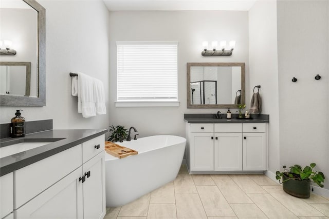 8112 Silhouette St, Austin, TX 78744 - full bath featuring a shower stall, a freestanding bath, and two vanities
