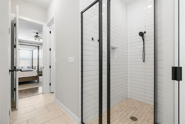 8112 Silhouette St, Austin, TX 78744 - ensuite bathroom with a stall shower, a ceiling fan, tile patterned flooring, and baseboards
