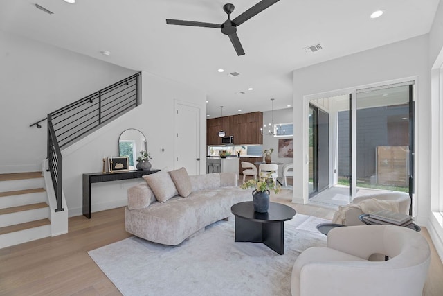 2114 Haskell St, Austin, TX 78702 - living area with ceiling fan, light wood-style flooring, stairway, plenty of natural light, and recessed lighting