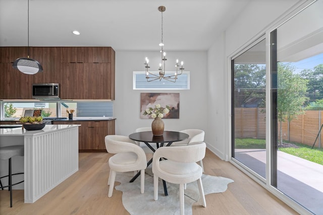2114 Haskell St, Austin, TX 78702 - dining space featuring a chandelier, light wood-style flooring, and recessed lighting