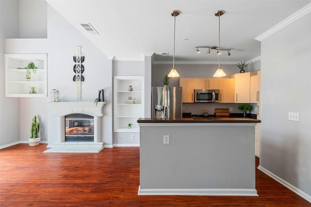 11203 Ranch Road 2222 1501, Austin, TX 78730 - kitchen with appliances with stainless steel finishes, dark countertops, dark wood finished floors, ornamental molding, and a glass covered fireplace