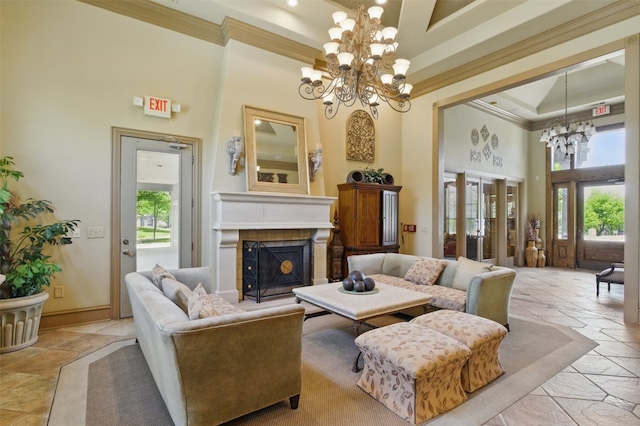 11203 Ranch Road 2222 1501, Austin, TX 78730 - living area featuring a chandelier, a high ceiling, crown molding, stone tile floors, and a fireplace