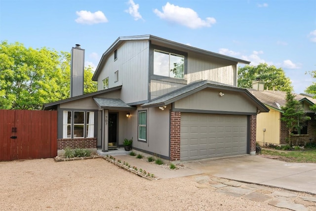 707 Mankato Dr, Austin, TX 78748 - view of front of home featuring a chimney, brick siding, a garage, and concrete driveway
