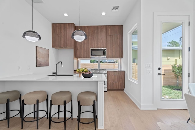 52 Robert T Martinez Jr St, Austin, TX 78702 - kitchen with stainless steel appliances, modern cabinets, brown cabinetry, and recessed lighting