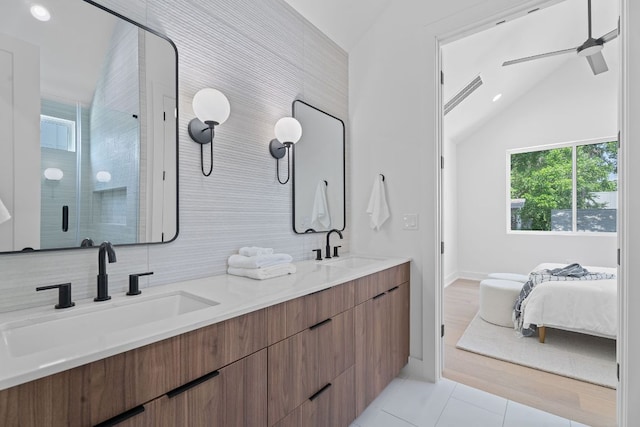 52 Robert T Martinez Jr St, Austin, TX 78702 - bathroom featuring vaulted ceiling, double vanity, a stall shower, ceiling fan, and tile patterned flooring